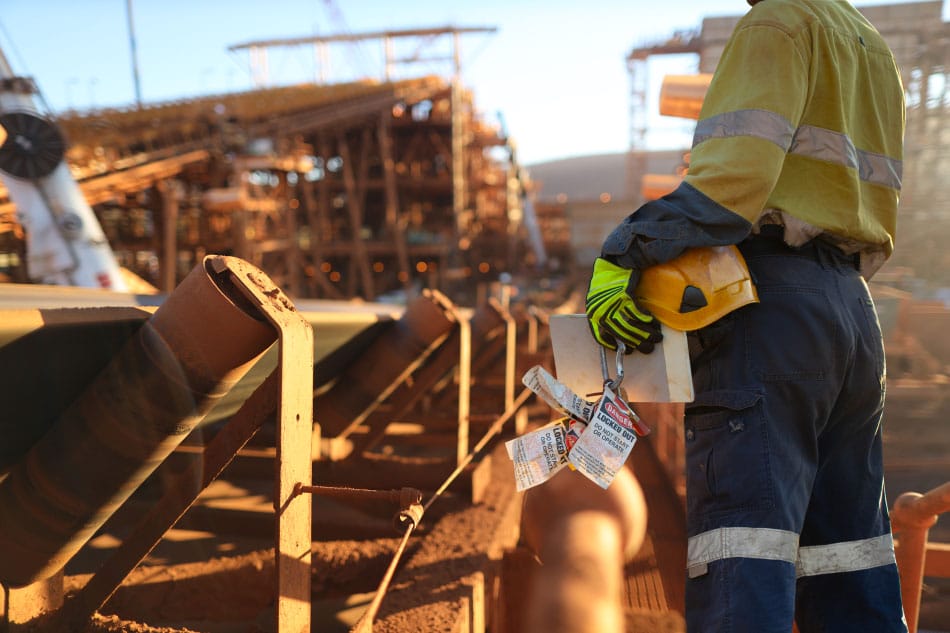 Employee holding lockout tagout device.