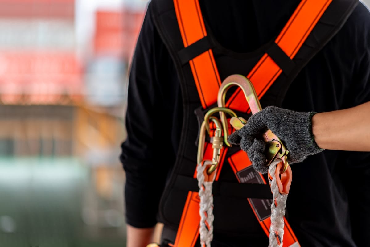 Construction worker using fall protection gear on a construction site
